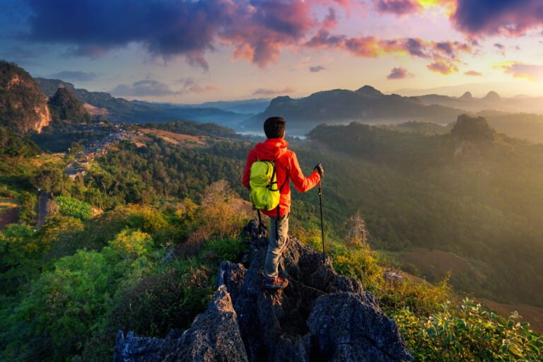 backpacker-standing-sunrise-viewpoint-ja-bo-village-mae-hong-son-province-thailand - best trip tips