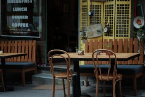 empty-cafe-street-terrace-with-chairs-tables-guests - best trip tips